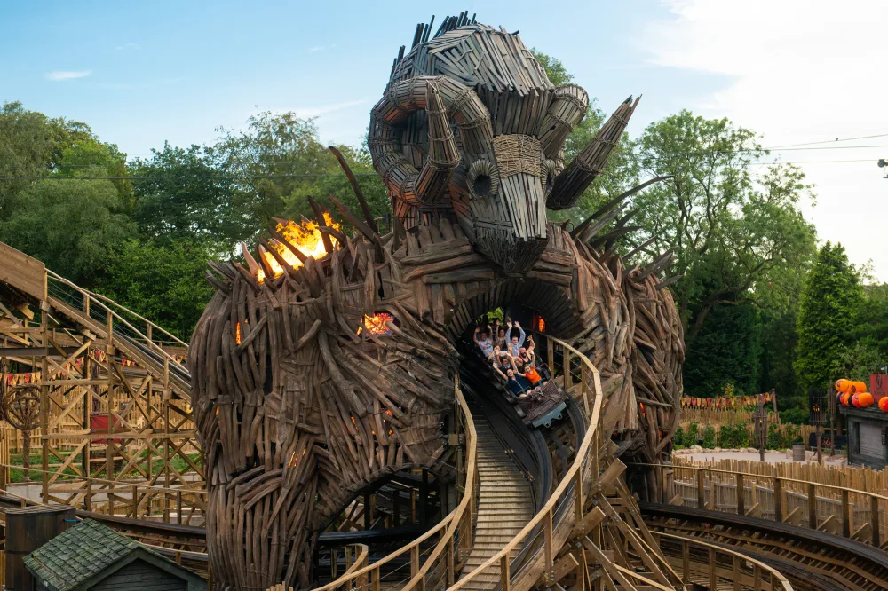 A carriage of people exits the Wicker Man roller coaster at Alton Towers