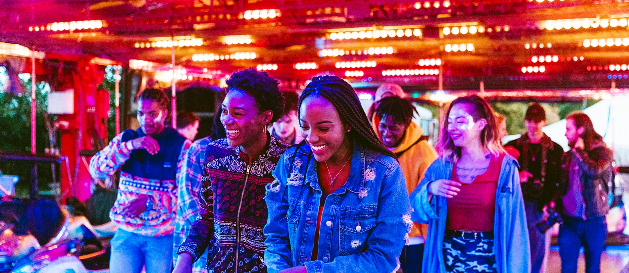 A group of young people enjoying a day out together at a fun fair